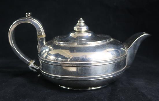 A George IV silver squat circular teapot by James Wintle, London, 1828.